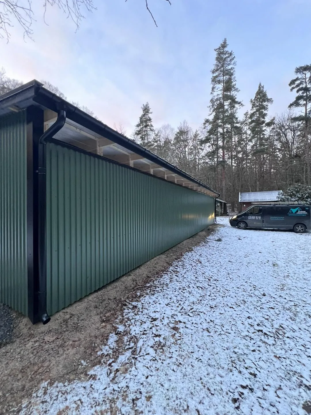 Fasaden monteras, med företagets firmabil intill.